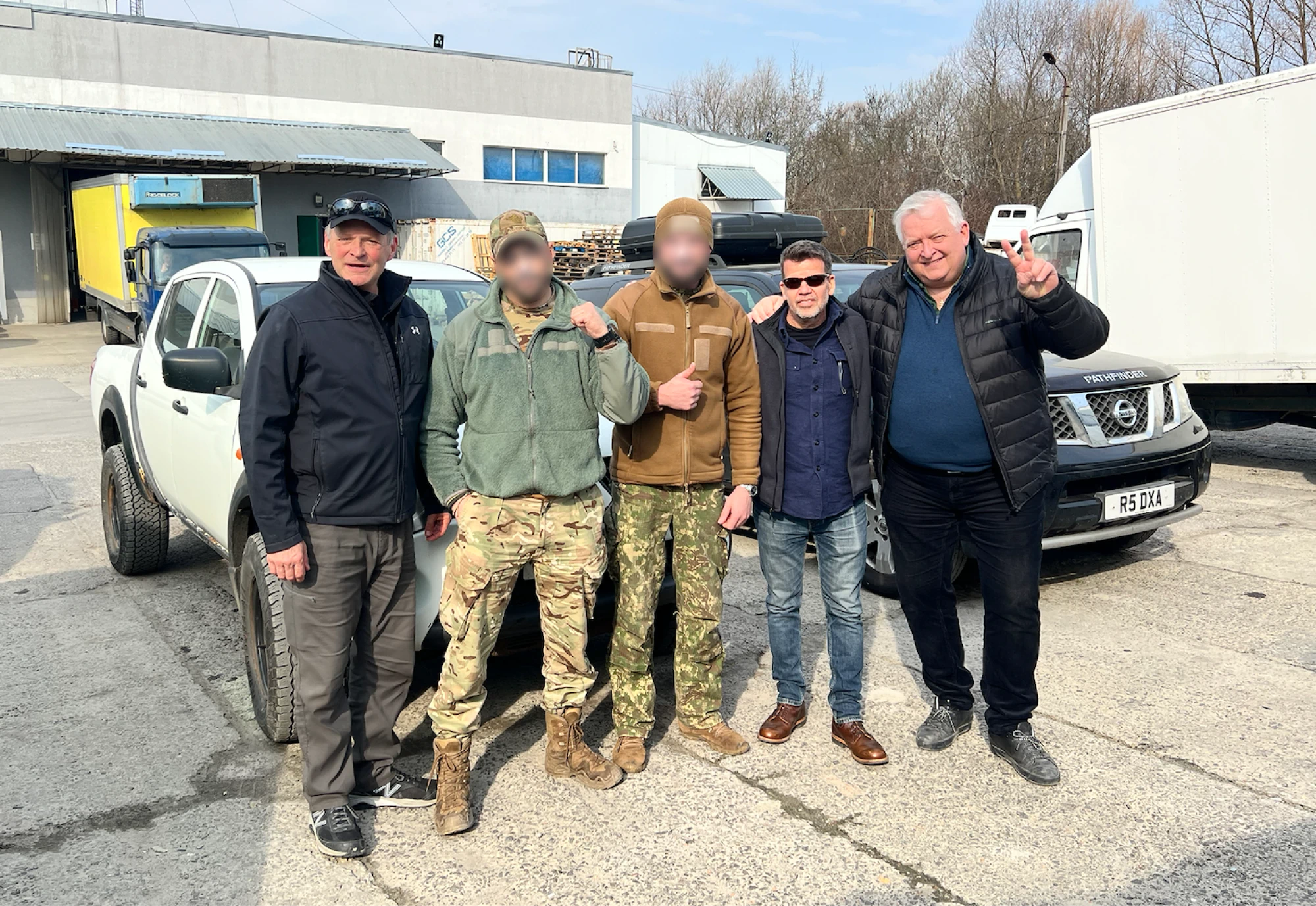 Handing off two vehicles to a couple soldiers. This was one of the more satisfying moments on the trip. These guys were extremely grateful. (Faces obscured at the request of the soldiers.)